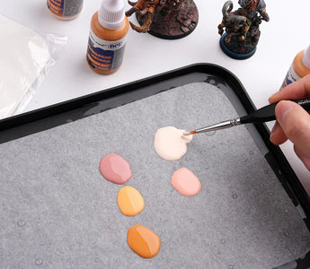 Mix acrylic paints for painting miniatures.