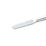 Close-up of a metal sculpting tool's flat, rounded spatula tip, perfect for smoothing and shaping.