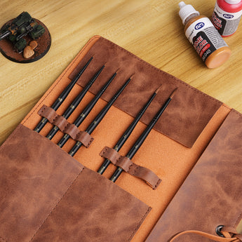 The miniature brushes are placed in the unfolded waterproof leather storage pouch.