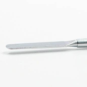 Close-up shot of the precise round tip of a metal sculpting tool, for fine detail work.