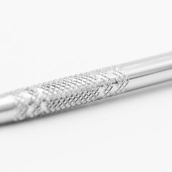 Close-up of the textured grip on a metal sculpting tool's handle, providing enhanced control for artists.