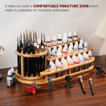 On the desktop are placed a brush and paint organizer, as well as a dry-brushing brush for miniatures.