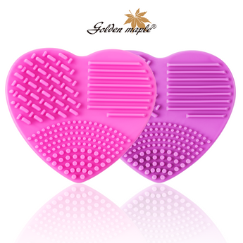 Silicone brush cleaners in pink and purple, heart-shaped.