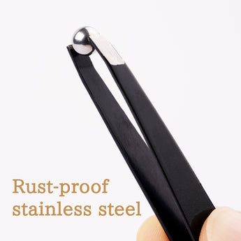 Tweezers holding a stainless steel mixing ball.