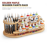 The wooden paintbrush organizer holds multiple paintbrushes and acrylic paints.