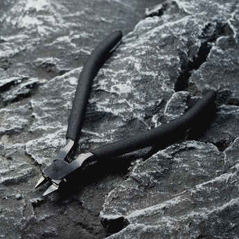A single-edged cutting pliers placed on a rock.​