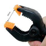 Close-up of Golden Maple spring clamp showing 30mm opening and textured orange gripping pads for precise model assembly.
