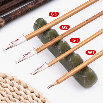 Traditional Chinese calligraphy brushes (G1, G2, G3, W1) with bamboo handles, displayed on a decorative jade brush rest.