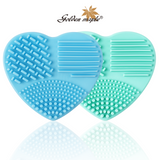 Blue and green heart-shaped silicone brush cleaners.